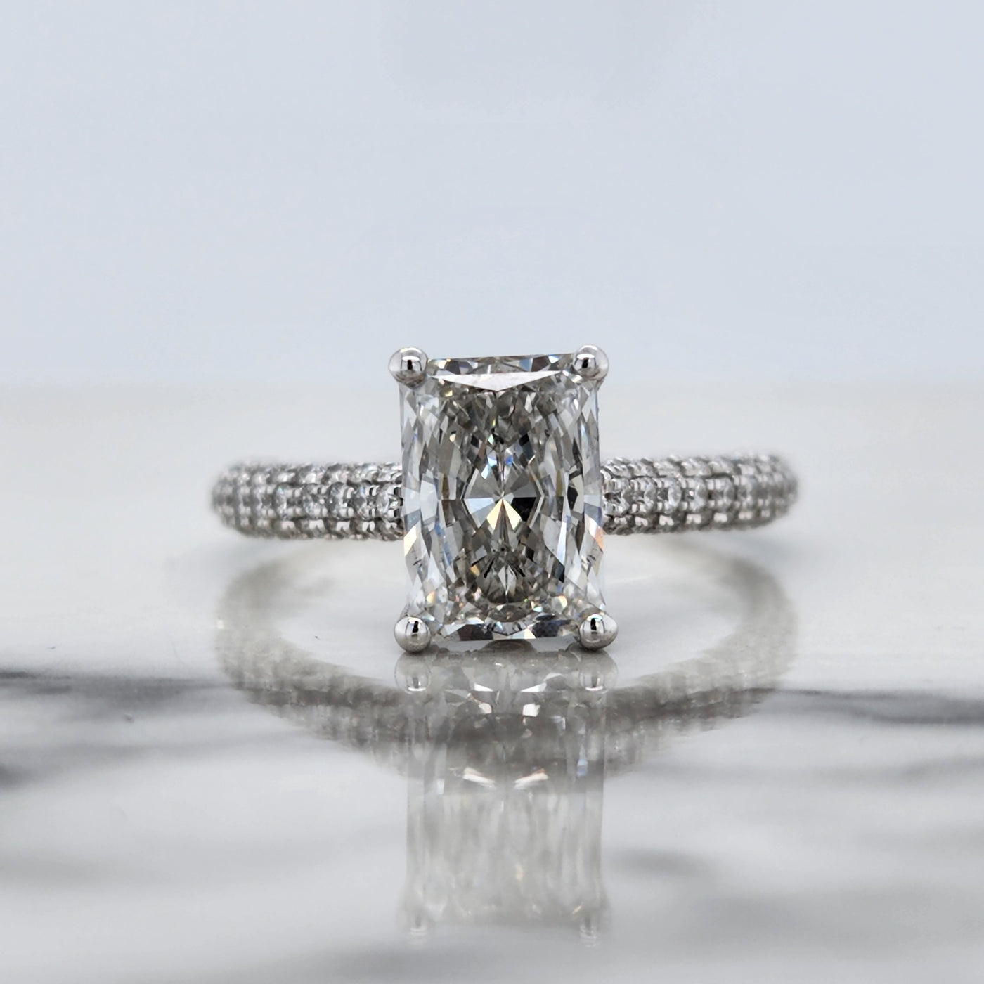 White Gold Engagement Ring With Radiant Cut Center and Round Accents