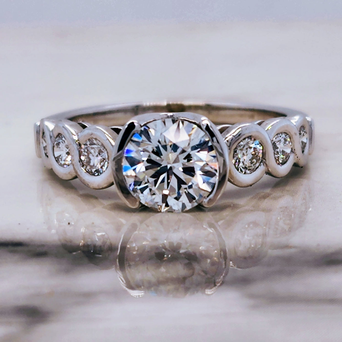 White Gold Engagement Ring With Round Half Bezel Diamond Center and Bezel Accents