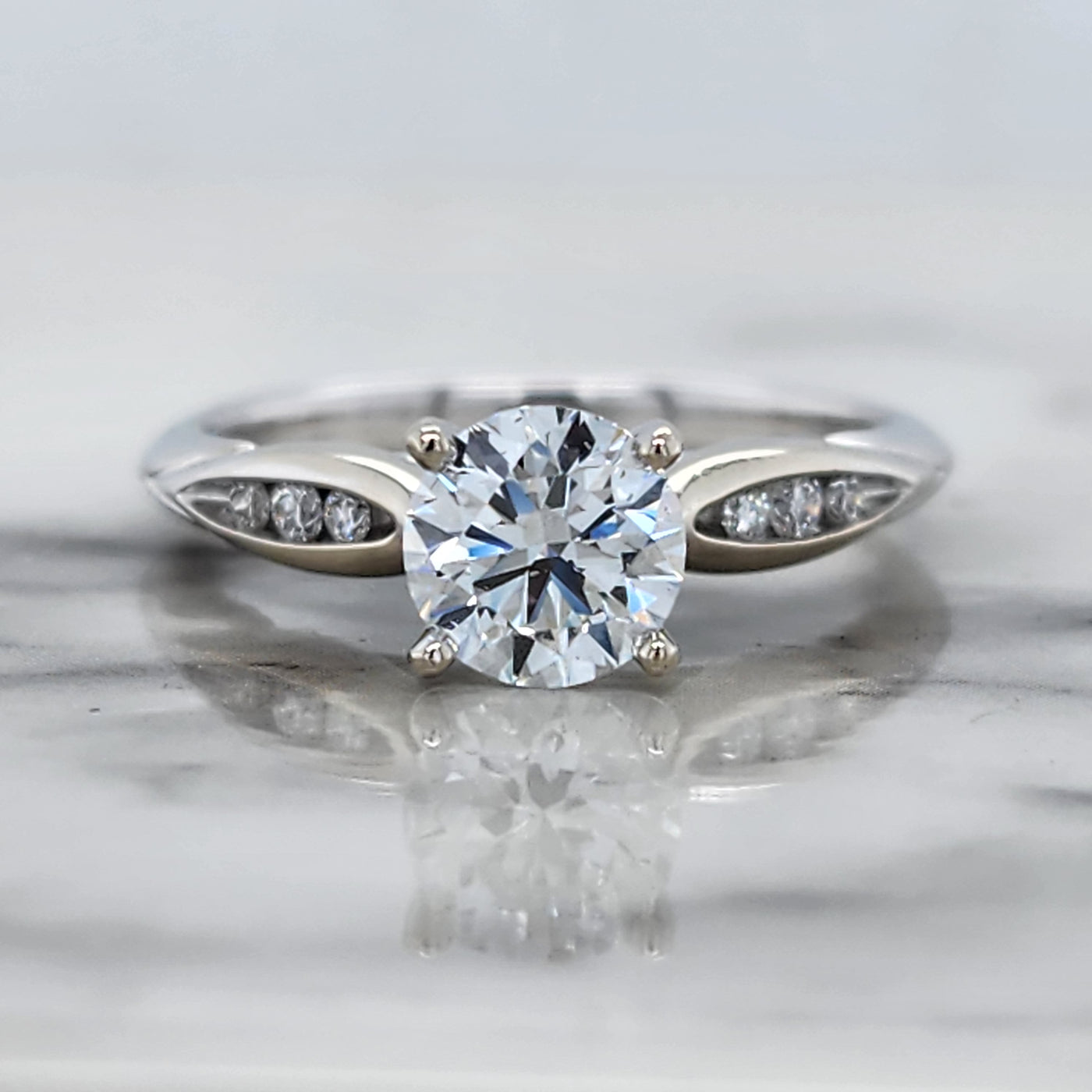 White Gold Engagement Ring With Round Center Stone and Channel Set Accent Stones