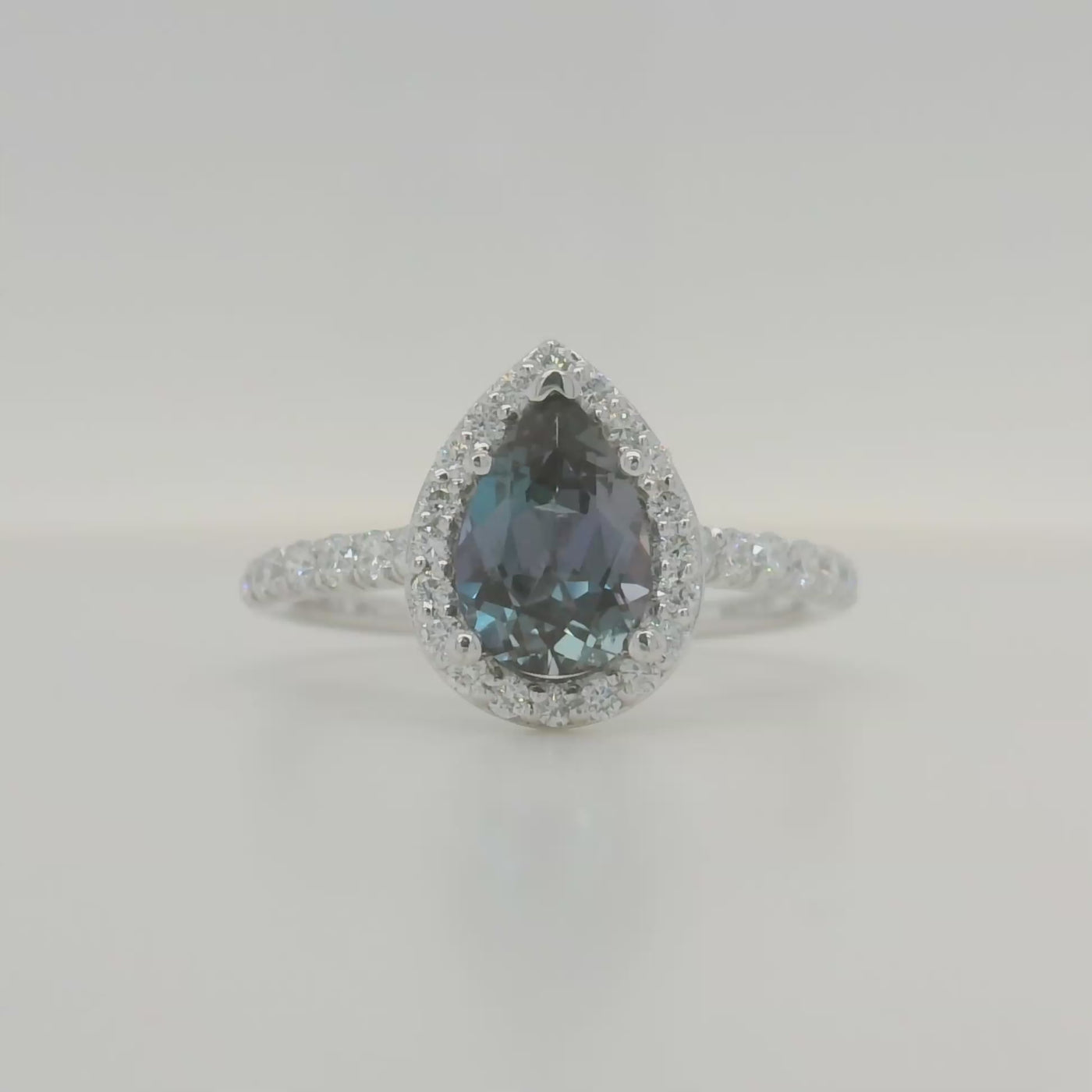 white gold lab grown pear alexandrite engagement ring with halo and accent diamonds