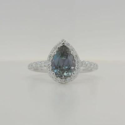 white gold lab grown pear alexandrite engagement ring with halo and accent diamonds