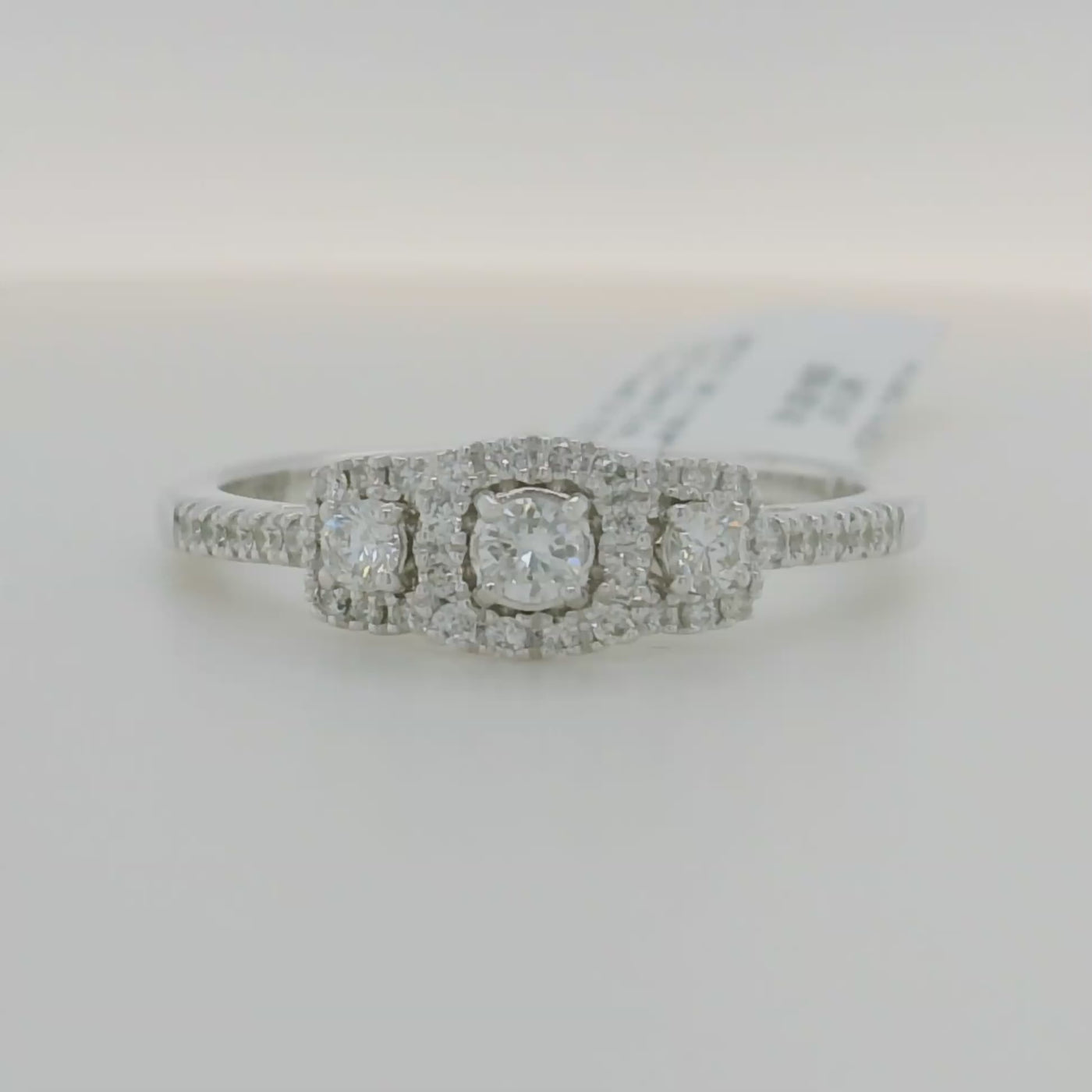 white gold round 3 stone ring with triple halo and accent diamonds