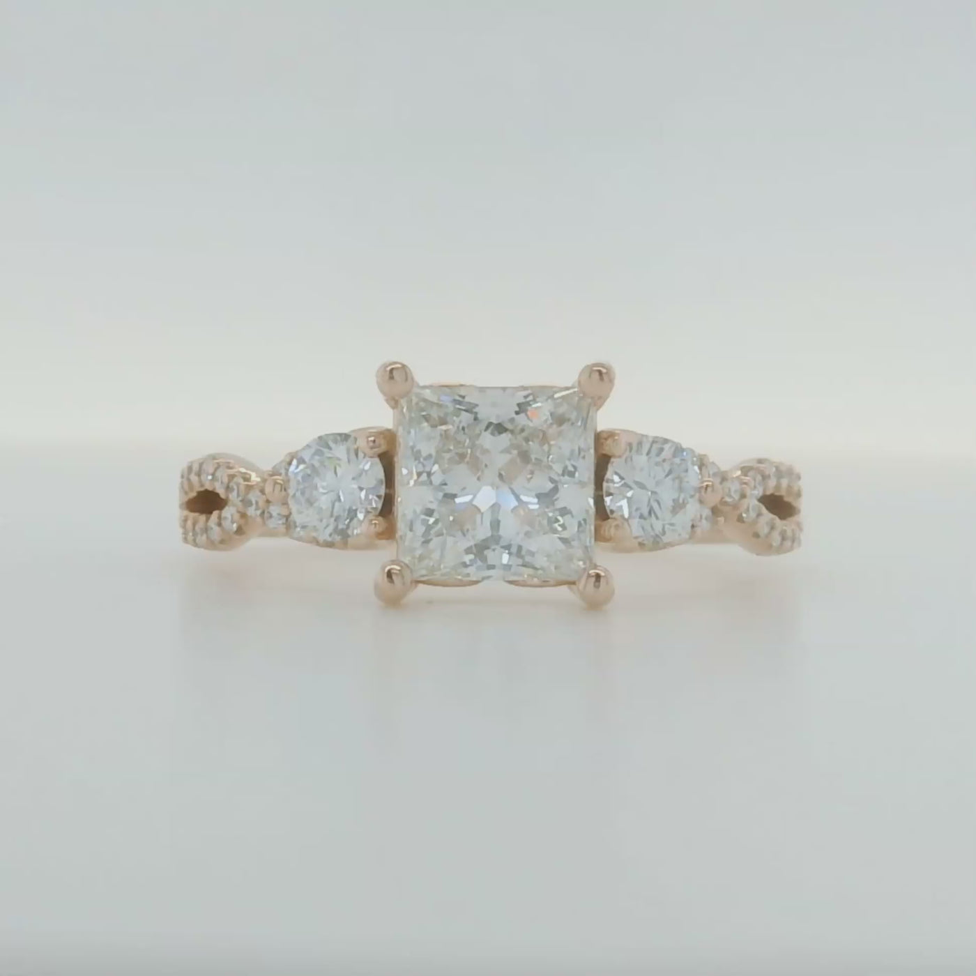 rose gold princess cut engagement ring with round accent diamonds